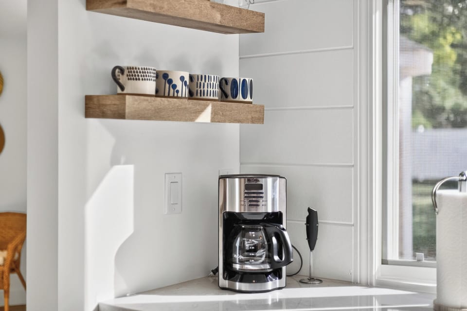 Kitchen includes coffee maker, French press, coffee grinder