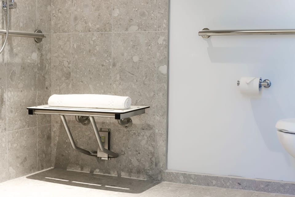 Thoughtfully designed for comfort, the accessible features of this bathroom ensure a stress-free experience.