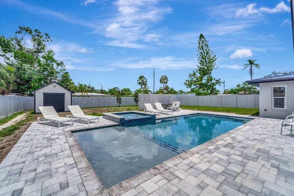 pool with sun shelf and hot tub