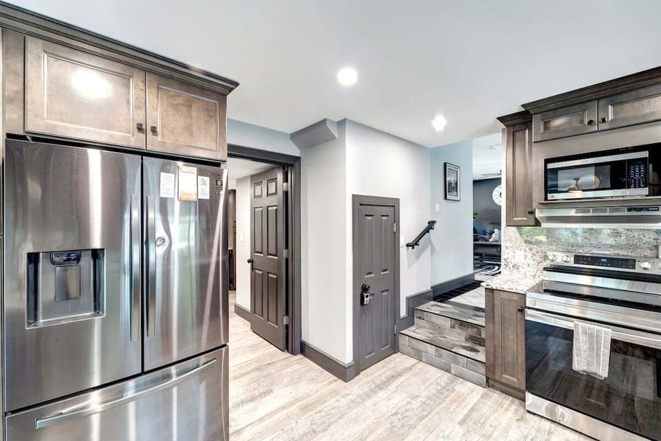 kitchen with view into living room to the right and bathroom straight ahead