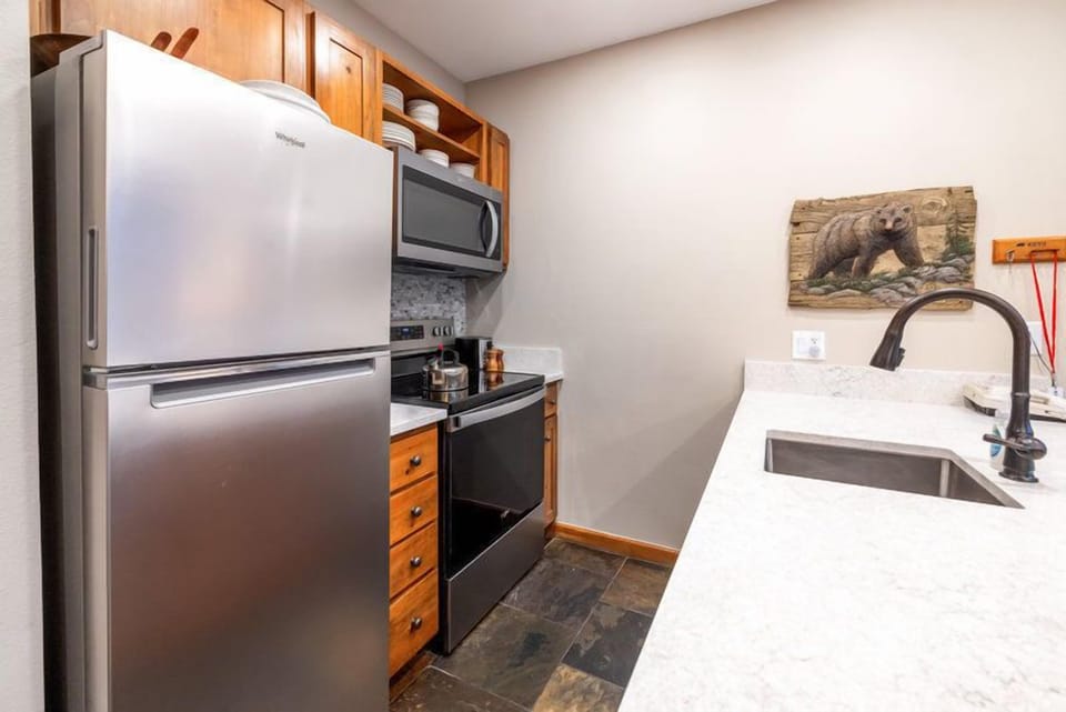 This well-equipped kitchen showcases modern appliances and rustic charm, perfect for whipping up a delicious meal after a day on the slopes.