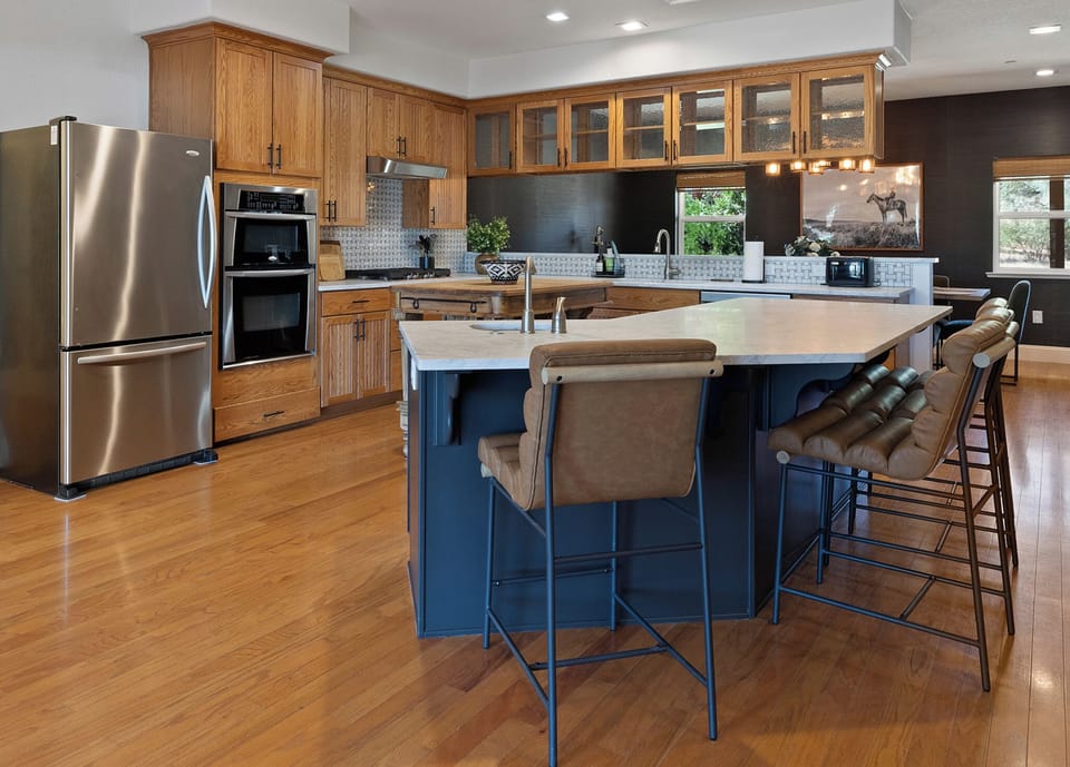 Beautiful open plan kitchen with 2 islands,  oven, gas stove and bar seating.