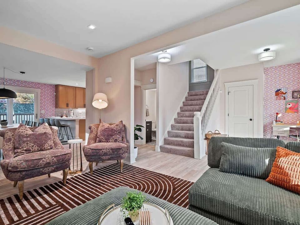 - Cozy living room with stylish seating and décor - Open floor plan connects seamlessly to kitchen - Perfect Airbnb home for family and friends