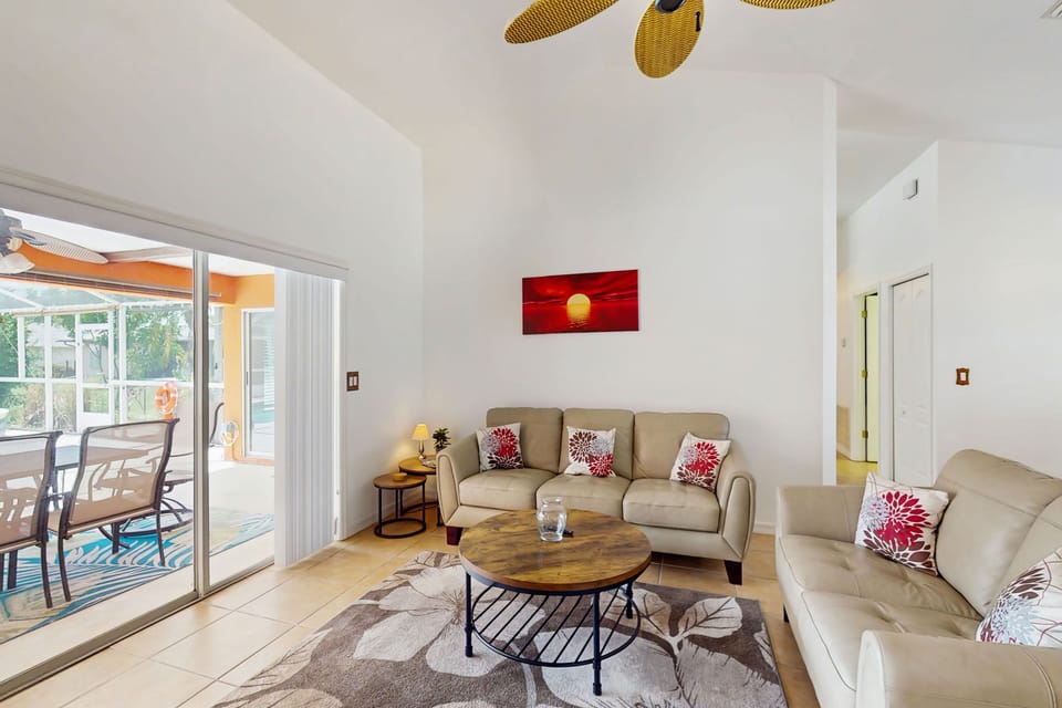 Bright & airy living room with sliding glass doors that lead to outdoor patio