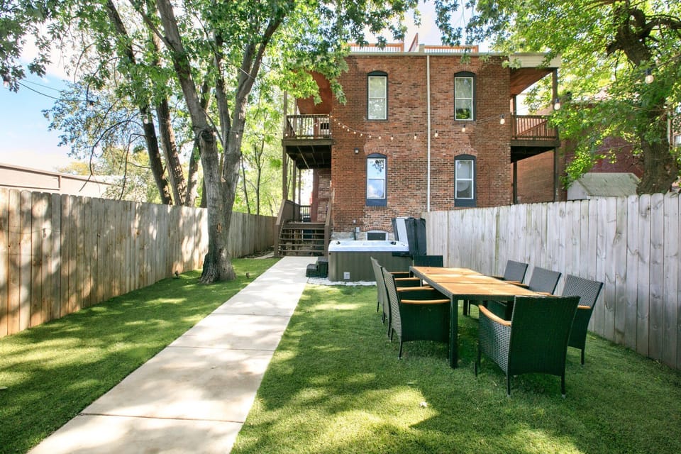The level lawn connects the hot tub and outdoor dining areas, creating a private space for relaxing and gathering.