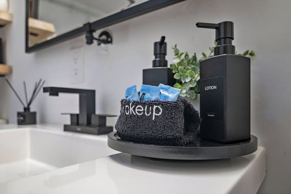 A neat vanity corner with fresh towels and everyday essentials within reach.