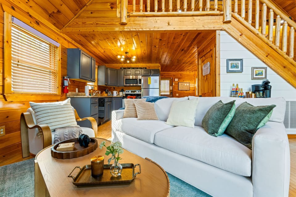 Open-concept cabin living - the great room flows seamlessly from the fully-equiped kitchen, soaring pine ceilings, log staircase to the master loft and the coffee/tea bar easily access 