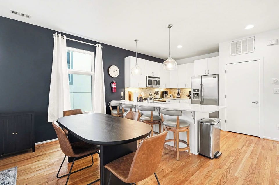 Enjoy meals together at the dining table which seats 4, with additional seating for 4 at the kitchen island.