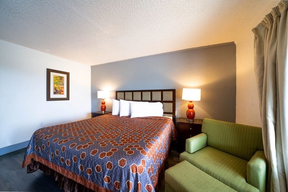 Unwind in a cozy king bed under warm lighting.