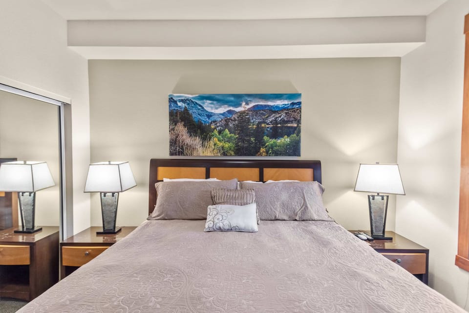 Luxurious King bed, ceiling fan, mirrored closet, and deck access.