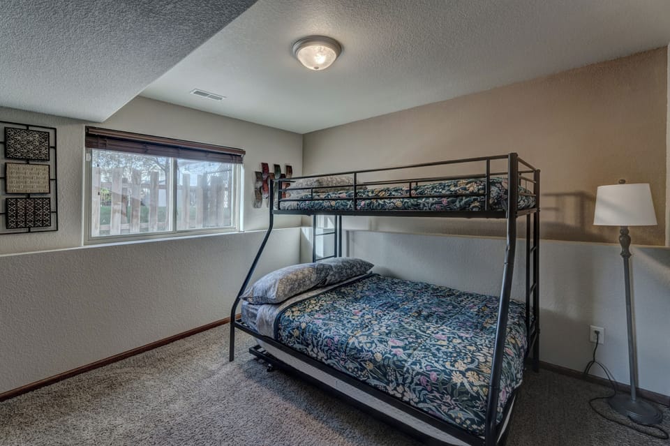 Kid's bedroom off of lower level living room with twin/full bunk bed with additional trundle bed - sleeps four children comfortably!