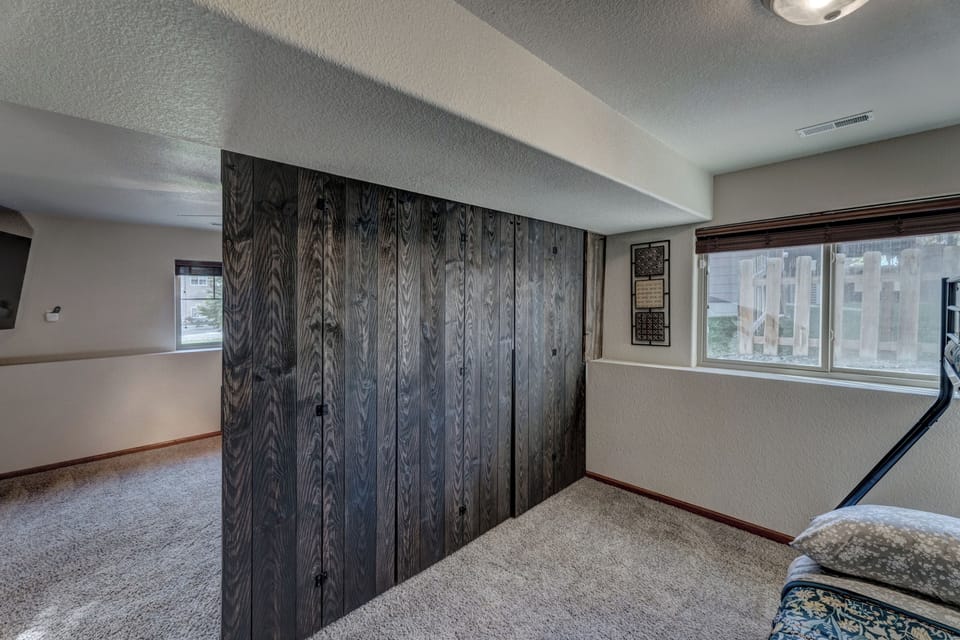Kid's bedroom off of lower level living room with twin/full bunk bed with additional trundle bed - sleeps four children comfortably!