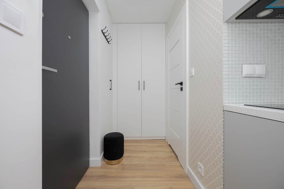 The view from the hallway into the kitchen highlights a practical layout that makes daily routines effortless during the stay.