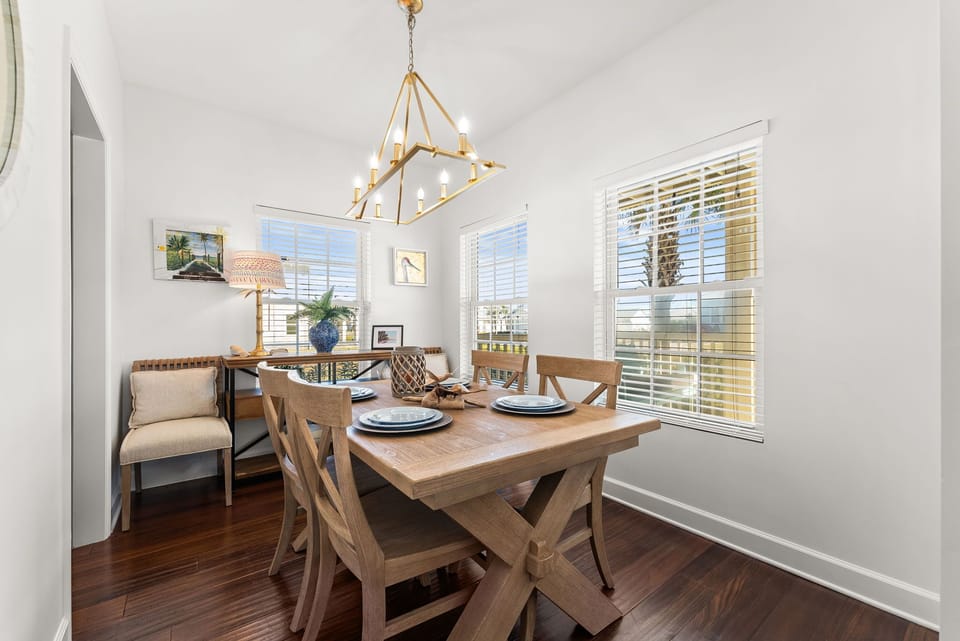 Your bright dining space features a stunning chandelier and warm wood table, perfect for memorable meals together.
