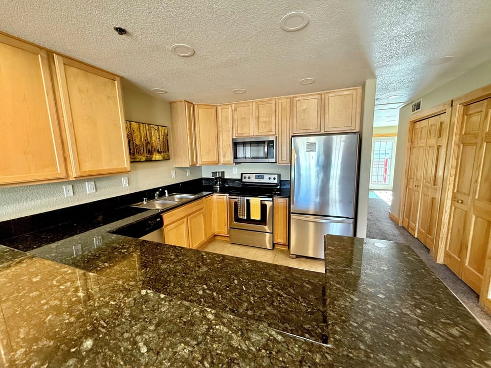 Full-size, updated kitchen with stainless steel appliances & granite countertops