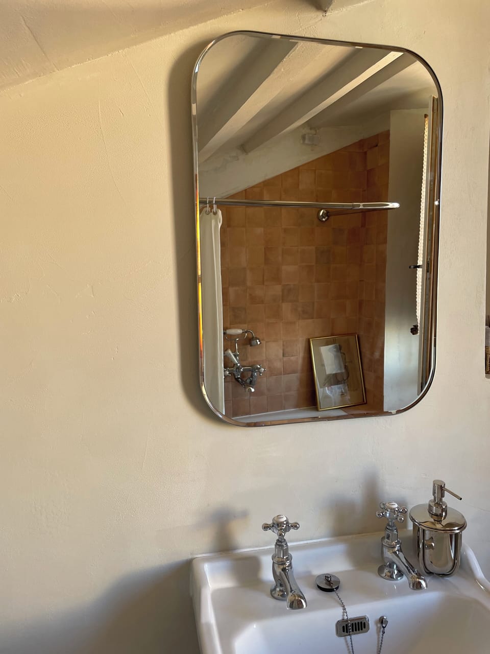 A play of reflection and material, connecting the bathroom’s elements.