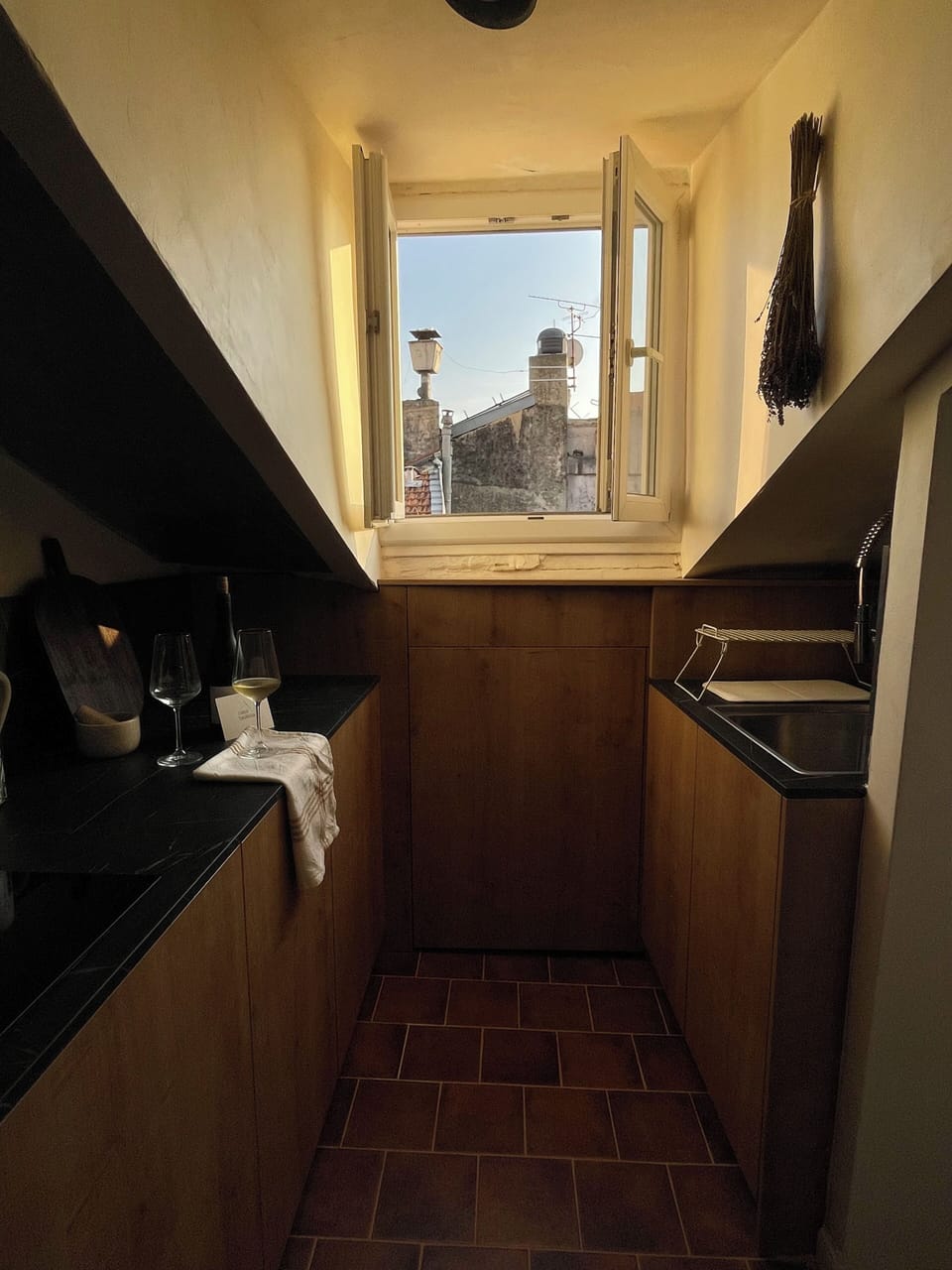 A compact kitchen that opens onto uninterrupted views of Old Nice rooftops.