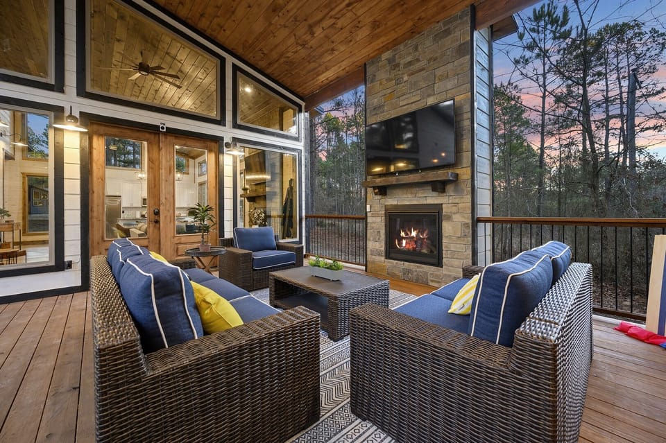 Under the covered breezeway, gather around the outdoor TV and fireplace, grill dinner, share meals, unwind in the hot tub, and cozy up on the conversation set.