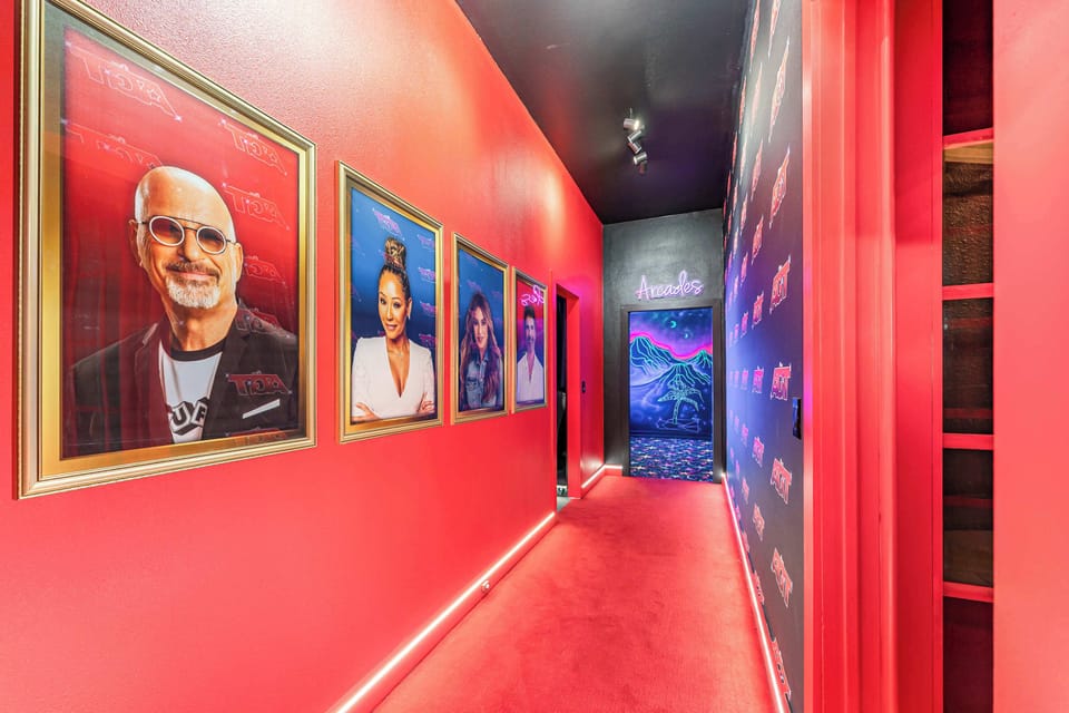 Down a red-carpet hallway, you’ll discover the show-stopping America’s Got Talent–style theater — a true performance and entertainment space complete with a stage, professional lighting, and comfortable seating for 15.