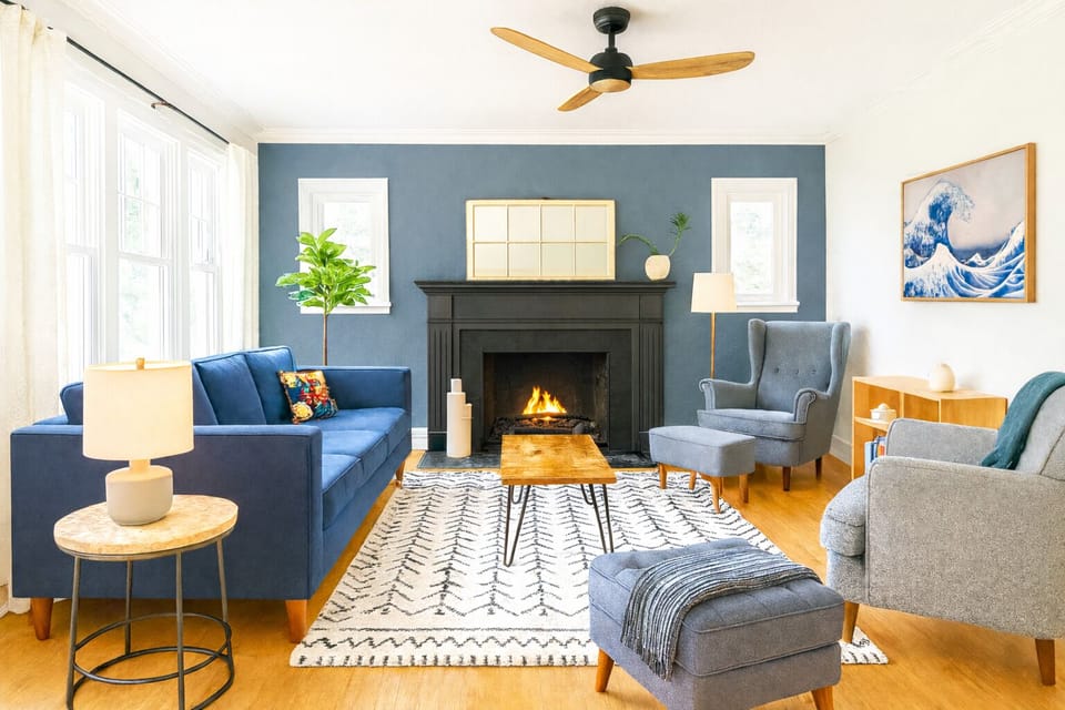 Bright, modern living room with natural light, cozy seating, and stylish décor