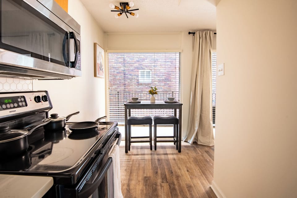 Functional kitchen with a sunny dining nook—ideal for home-cooked meals. 