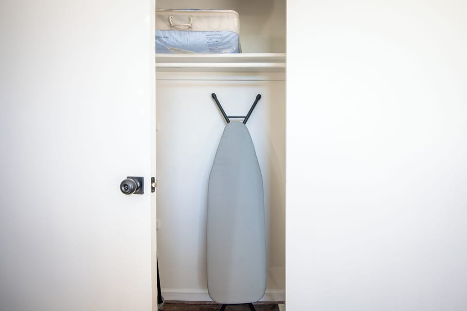 Stocked closet with linens and ironing station—everything you need for a comfortable stay.