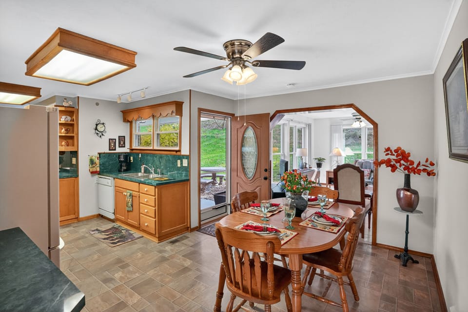 Welcoming dining area with sunroom view