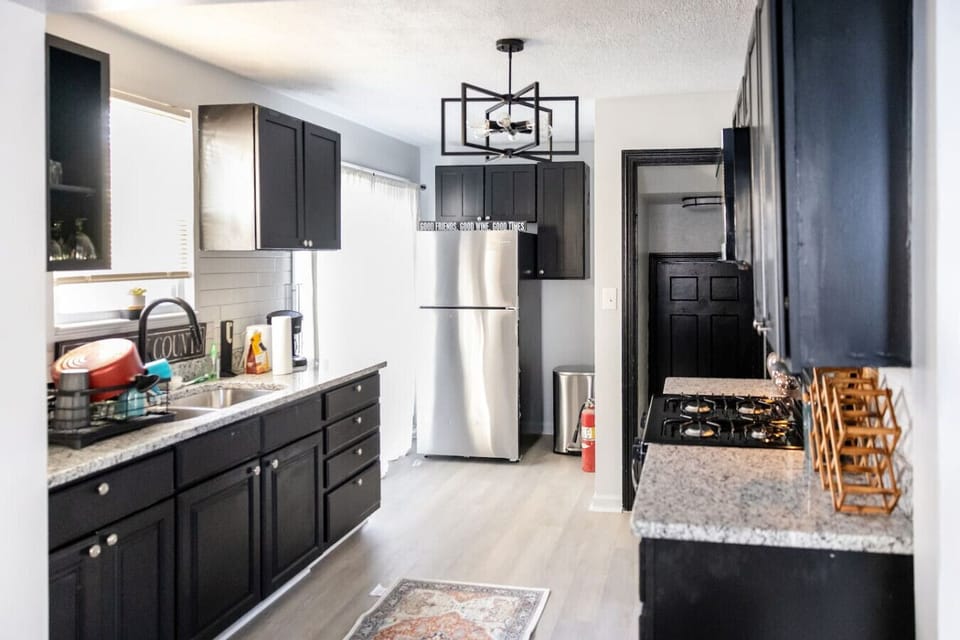 Prepare your favorite meals in this modern, fully equipped kitchen featuring sleek stainless steel appliances, ample counter space, and a clean, minimalist design.