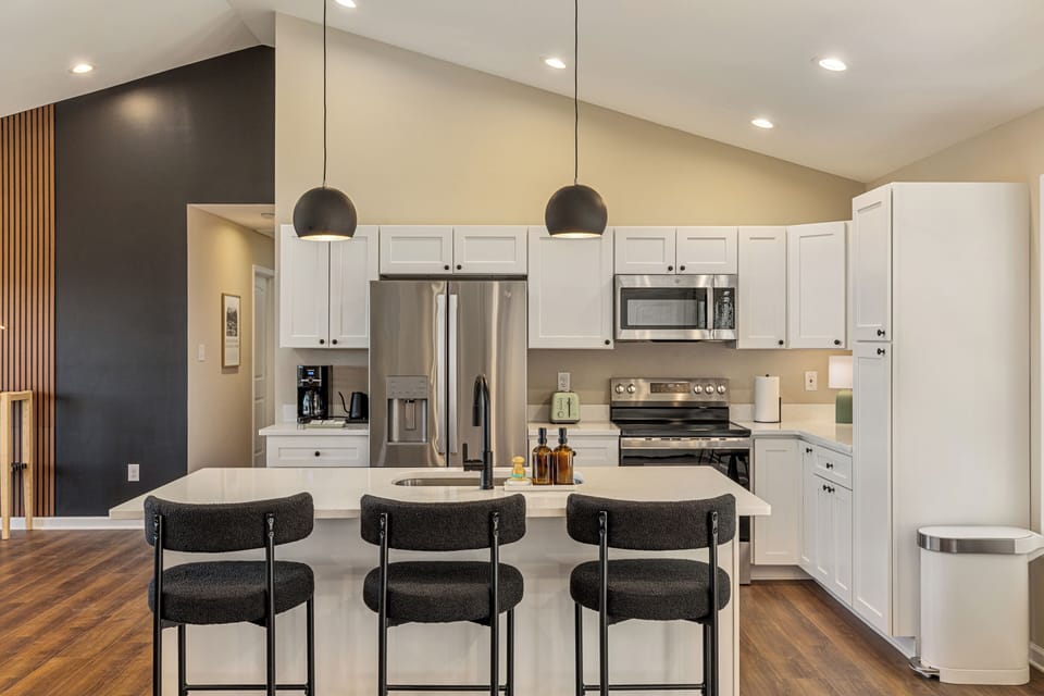 Modern kitchen & dining area perfect for family meals. Fully stocked with cookware, dishes, utensils & appliances. Includes dishwasher pods, dish soap, fresh sponge, paper towels & spices. Everything you need to cook comfortably!