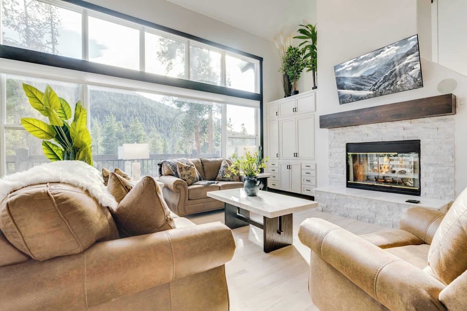 Primary floor living room with fireplace, tv, whole house sound system, and mountain views.