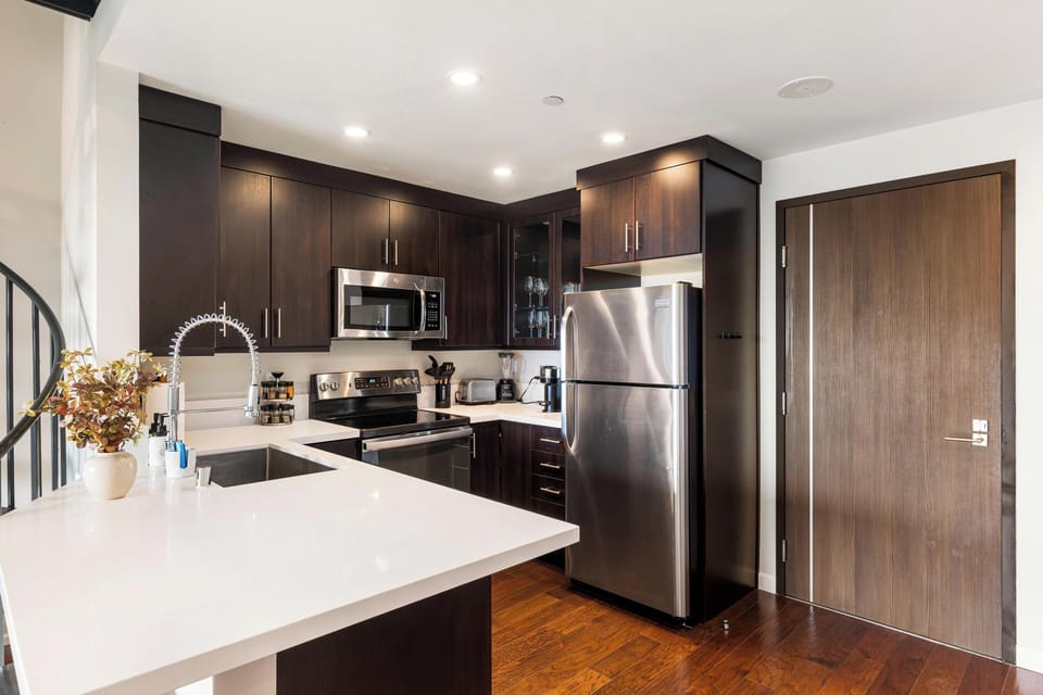 Featuring sleek stainless steel appliances throughout the space.