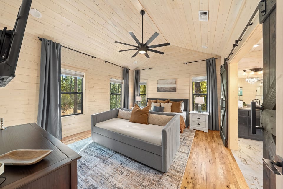 This serene king suite also includes a hidden Murphy bed that folds down for extra sleeping space, perfect for families, friends, or anyone who wants a flexible, beautifully designed room.