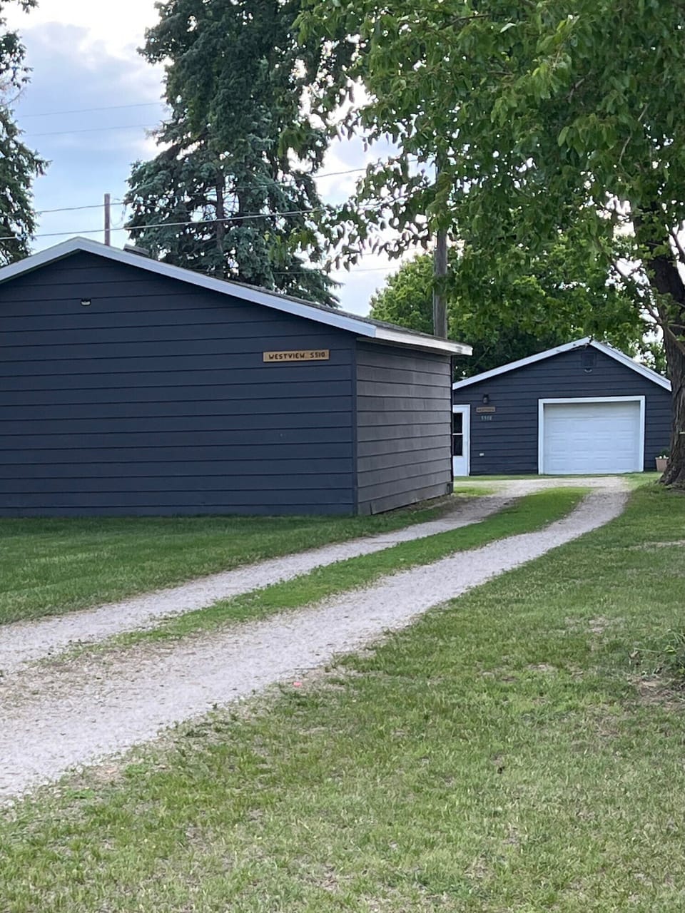 Detached garage at front of property, driveway entrance