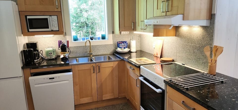 Full size fridge with freezer. Dishwasher. Stove. Granite counters. Coffee maker