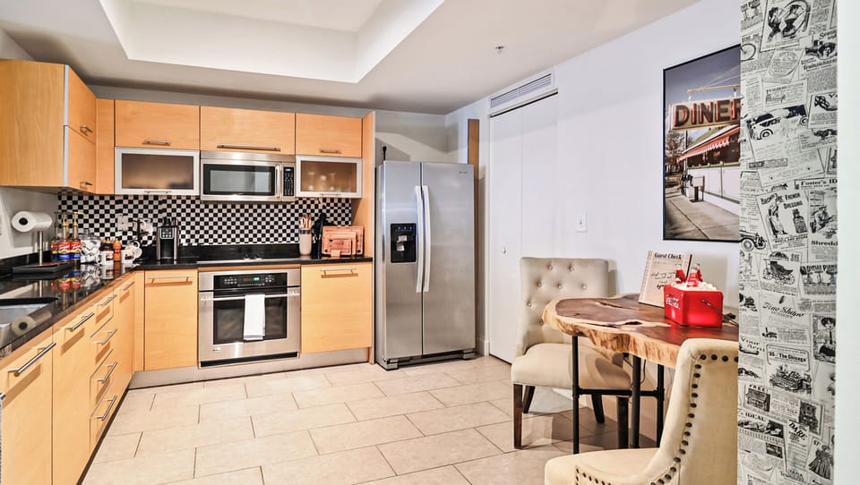 Modern kitchen with stainless steel appliances & fun diner decor.