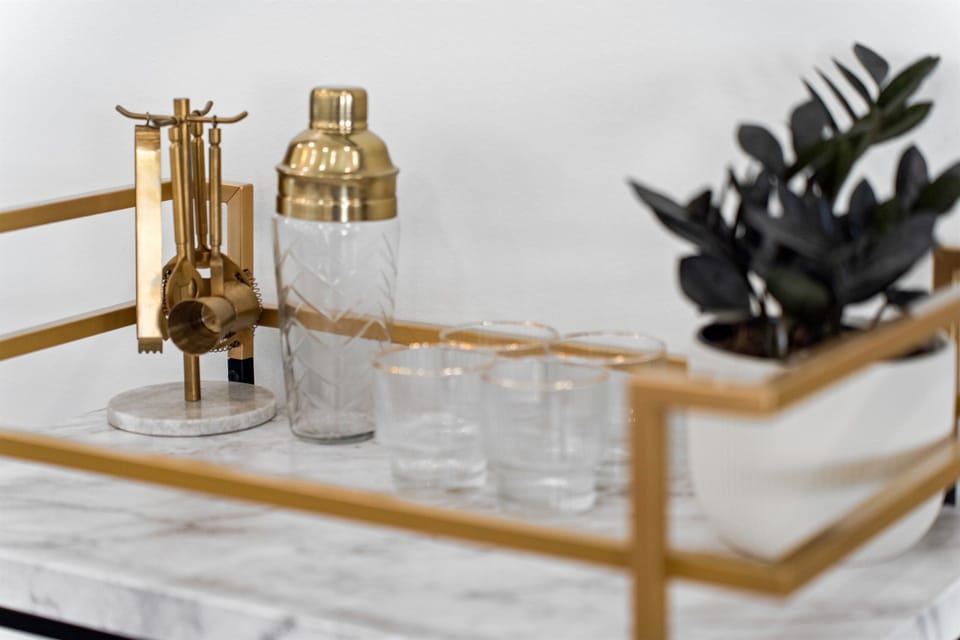 Stylish bar cart set up with glassware and essentials, perfect for entertaining or enjoying a quiet evening drink.