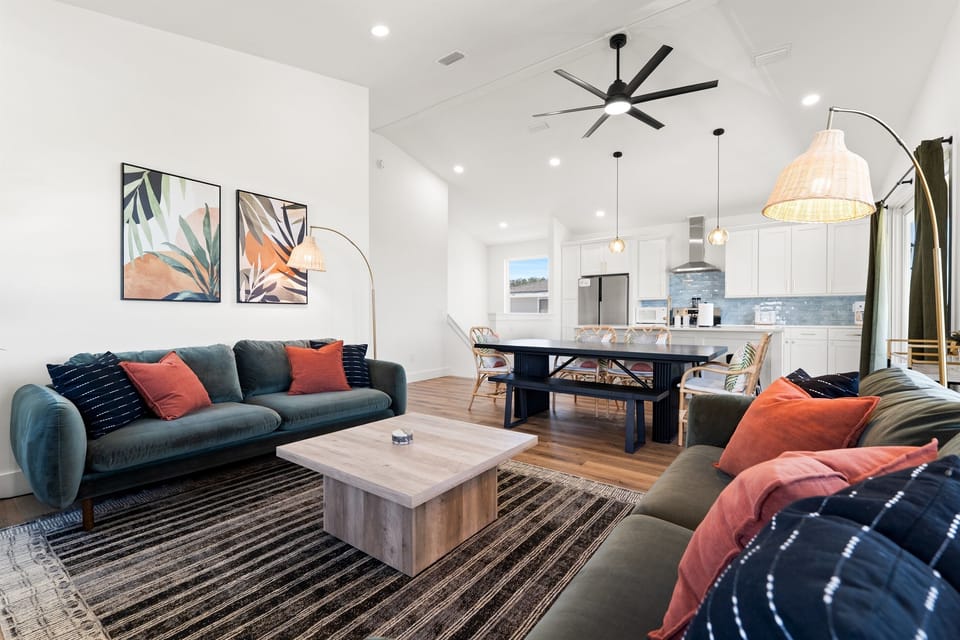 Bright and inviting living room featuring modern furnishings, large windows, and an open layout.