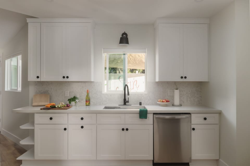 With natural light, sleek finishes, and a view of the backyard mural, this bright kitchen makes everything from breakfast to charcuterie feel a little more special.