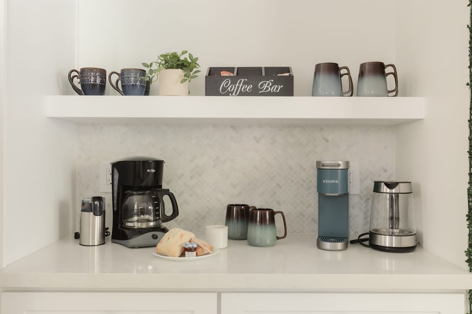 Your morning ritual, upgraded: Our coffee bar includes a drip machine, Keurig, grinder, and a variety of mugs so everyone can start the day their way.