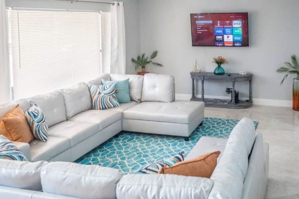 Family fun central! ️ Our family room boasts double sectional sofas and a smart TV, with views of both the pool deck and the pool table room. It`s the heart of entertainment in our home! #FamilyTime #EntertainmentHub