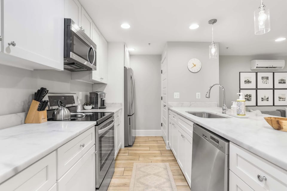 Fully equipped modern kitchen with stainless steel appliances and quartz countertops