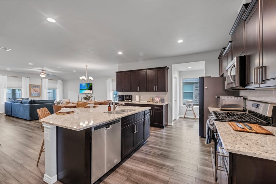 Modern chef-ready kitchen with stainless-steel appliances and a large island for cooking and entertaining.