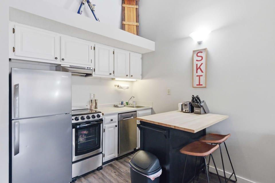 Fully stocked kitchen with bar seating—perfect for breakfast before hitting the slopes.
