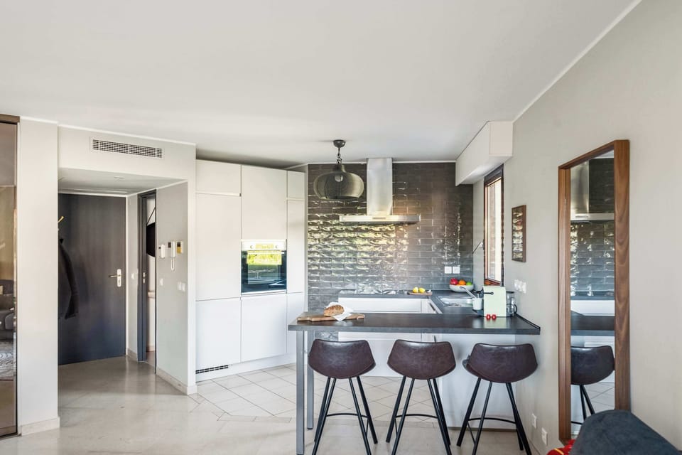 Open-concept layout connecting kitchen, bar, and living area — the perfect social hub for your stay.