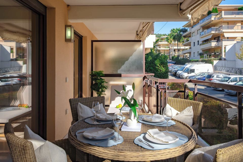 Balcony of Room 22: Upper-level balcony overlooking the neighborhood — enjoy breakfast or evening wine in this open-air retreat with stylish rattan seating.