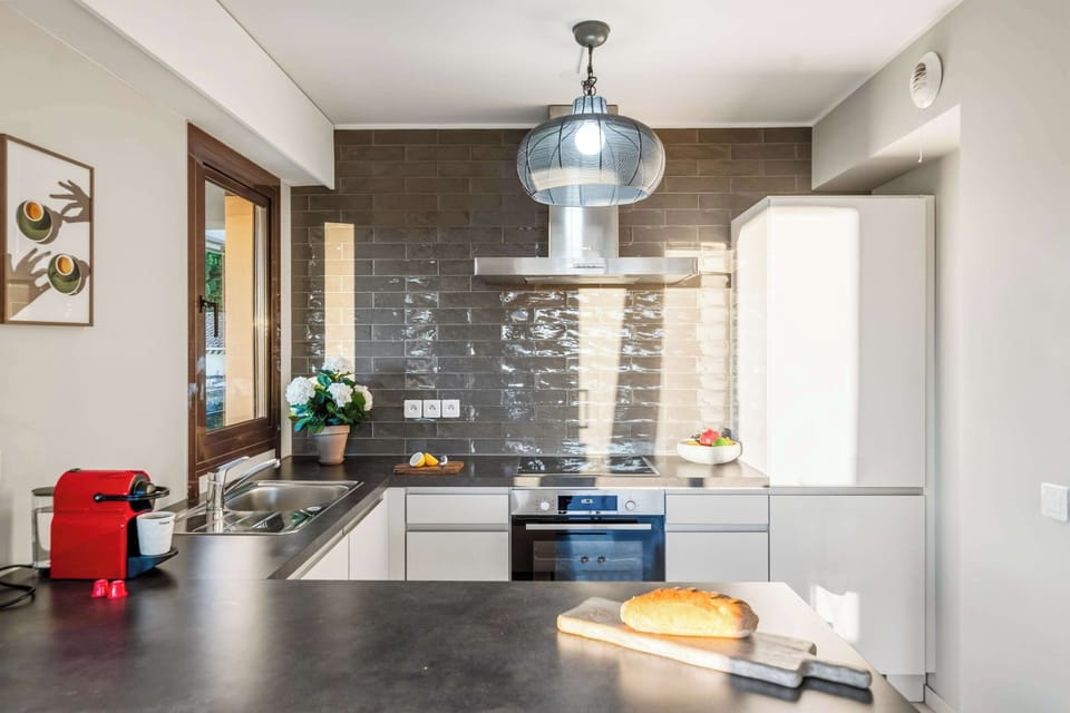 Full-size fridge, oven, and coffee setup in this thoughtfully designed kitchen — everything you need for a comfortable self-catering holiday.