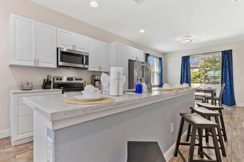 Spacious kitchen with island seating for four and easy access to the dining area.