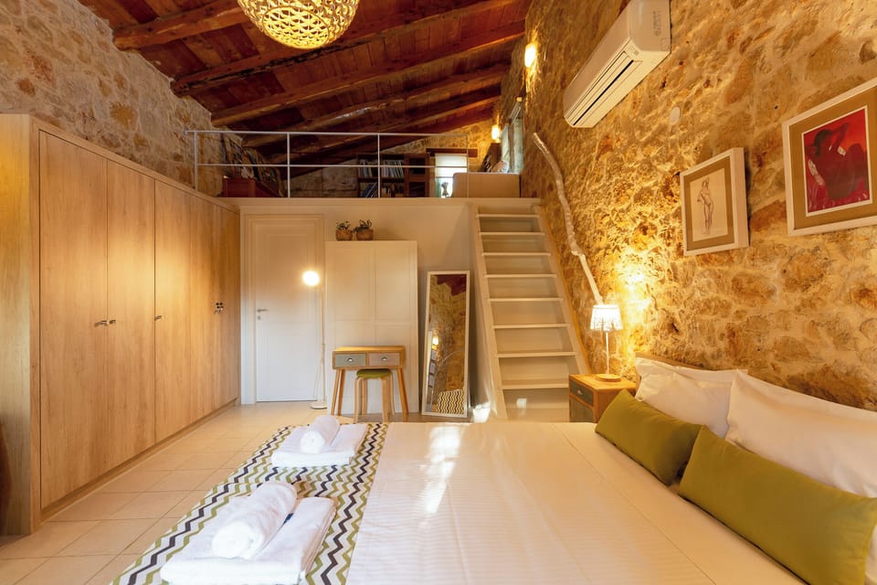 Studio-style bedroom with fireplace, living area and dedicated bathroom.