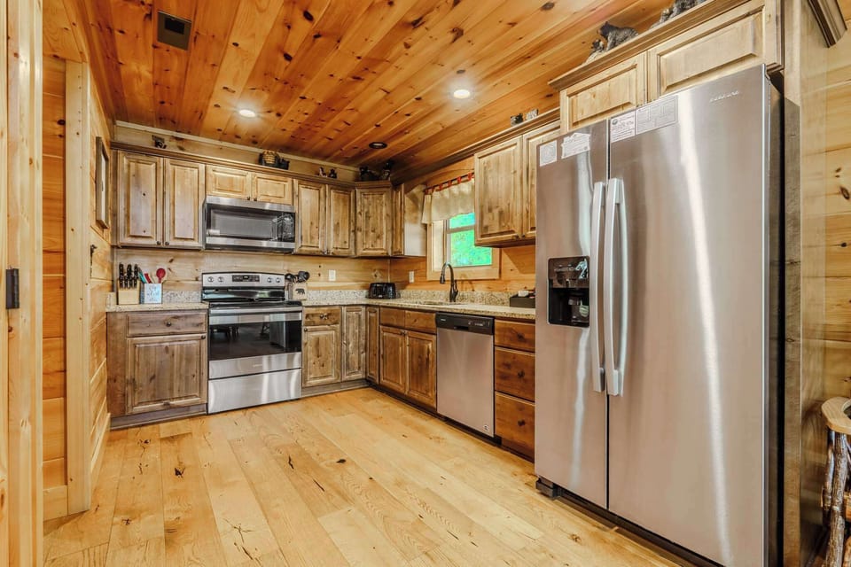 Whip up culinary delights in this rustic kitchen with modern appliances and granit countertops!