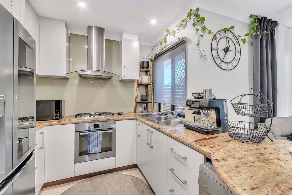 Prepare meals in the fully equipped kitchen boasting an oven, dishwasher, gas cooktop, granite countertops, and a Nespresso machine ready for your morning brew.